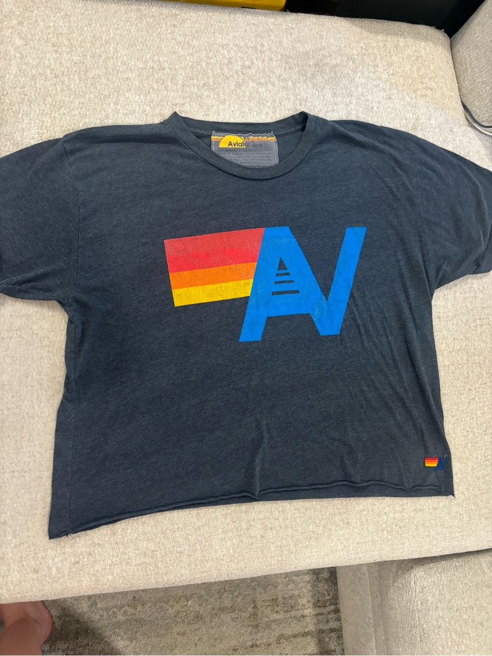 Aviator Nation Black Tee with Blue Logo and Red-Yellow Stripe